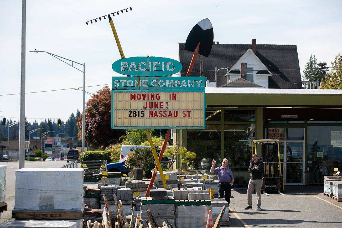 Pacific Stone Company owner Tim Gray talks with relocation agent Dan Frink under the iconic Pacific Stone sign on Friday, May 3, 2024, in Everett, Washington. The business will be relocating to Nassau Street near the intersection of Marine View Drive and California Street. (Ryan Berry / The Herald)