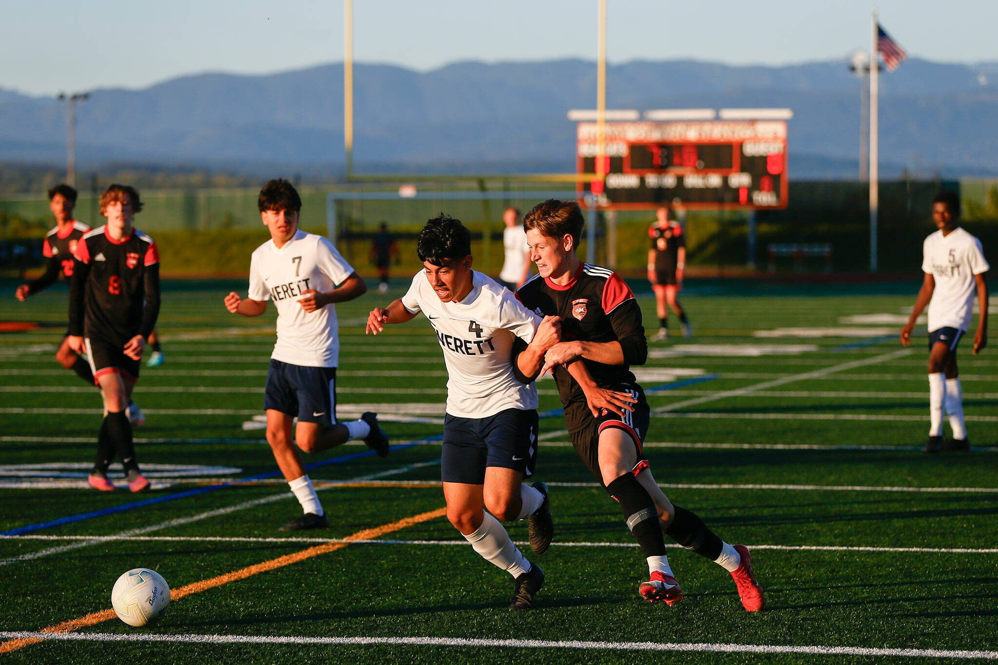 Monroe’s Trent Skurdal pesters Everett’s Roberto Mata Castellon during a 3A District soccer match on Thursday, May 2, 2024, at Monroe High School in Monroe, Washington. (Ryan Berry / The Herald)