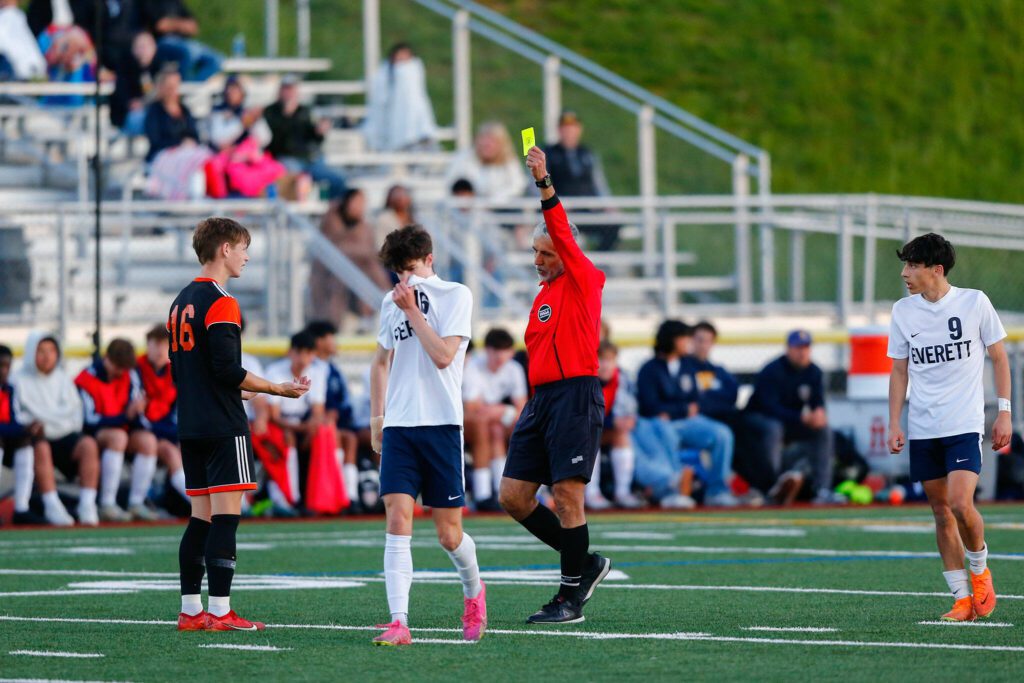 Monroe’s Trent Skurdal is called for a yellow card during a 3A District soccer match against Everett on Thursday, May 2, 2024, at Monroe High School in Monroe, Washington. (Ryan Berry / The Herald)
