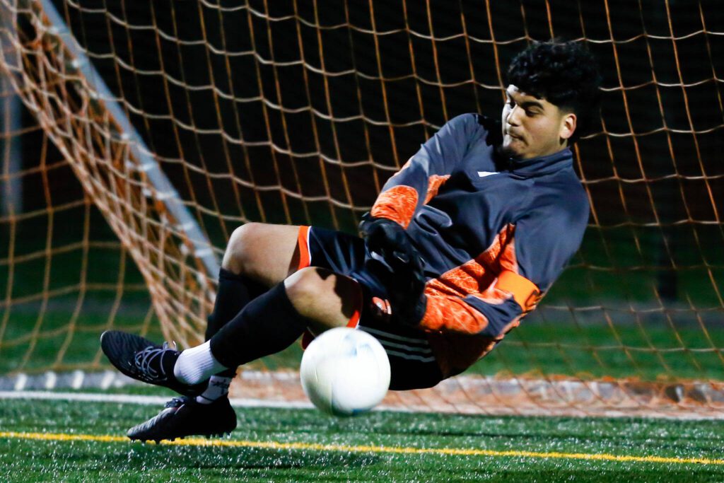 Monroe goalkeeper Brandon Alonso makes a save during penalty kicks in a 3A District soccer match against Everett on Thursday, May 2, 2024, at Monroe High School in Monroe, Washington. (Ryan Berry / The Herald)
