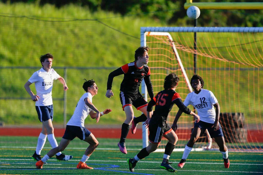 Monroe’s Tanner Summers heads the ball upfield during a 3A District soccer match against Everett on Thursday, May 2, 2024, at Monroe High School in Monroe, Washington. (Ryan Berry / The Herald)
