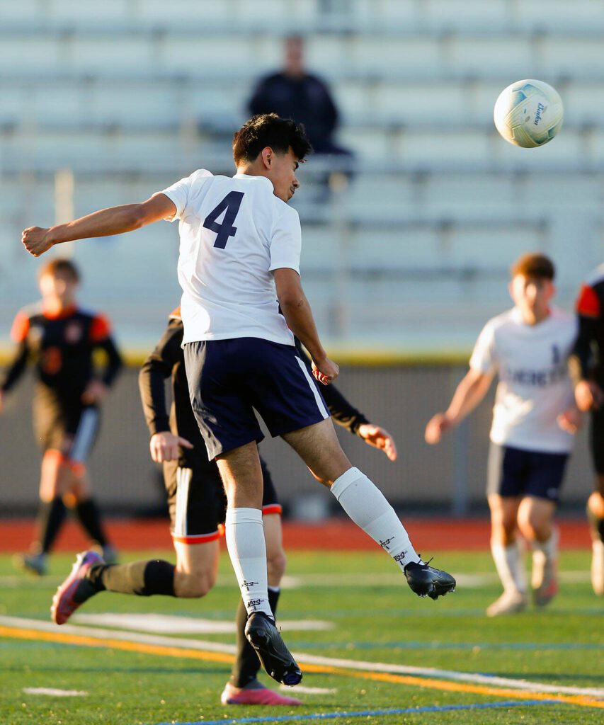 Everett’s Roberto Mata Castellon heads the ball away from the goal during a 3A District soccer match against Monroe on Thursday, May 2, 2024, at Monroe High School in Monroe, Washington. (Ryan Berry / The Herald)
