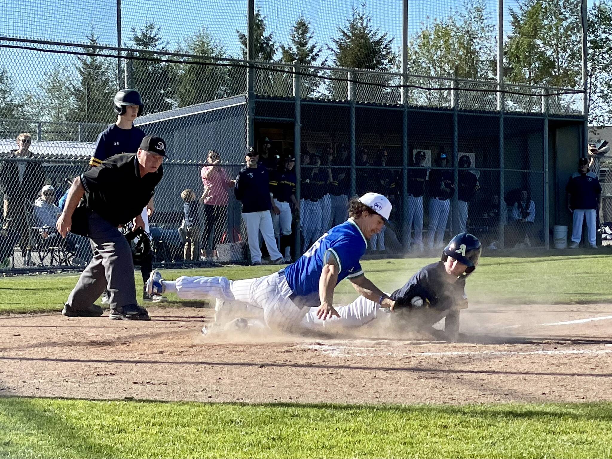 Arlington’s Reece Boekenoogen scores a run under the tag attempt of Shorewood’s Joey Facilla in Thursday’s Class 3A District 1 baseball game. Arlington won 3-0. (Aaron Coe / The Herald)