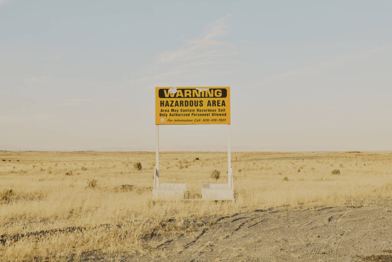 A radiation warning sign along a road near the Hanford Site in Washington state, on Aug. 10, 2022. Hanford, the largest and most contaminated of all American nuclear weapons production sites, is too polluted to ever be returned to public use. Cleanup efforts are now at an inflection point. (Mason Trinca / New York Times file photo)