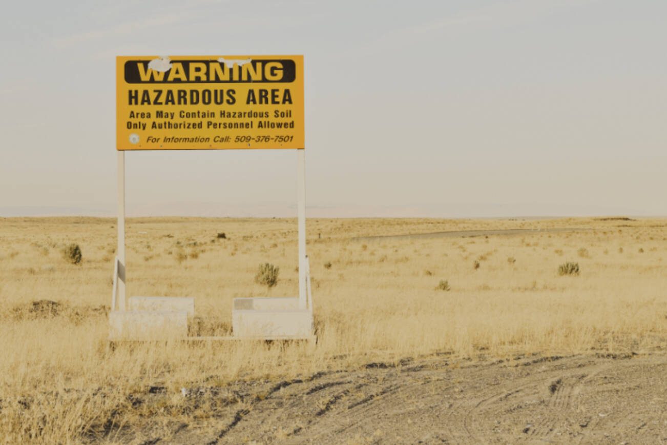 A radiation warning sign along the road near the Hanford Site in Washington state, on Aug. 10, 2022. Hanford, the largest and most contaminated of all American nuclear weapons production sites, is too polluted to ever be returned to public use. Cleanup efforts are now at an inflection point.  (Mason Trinca/The New York Times)