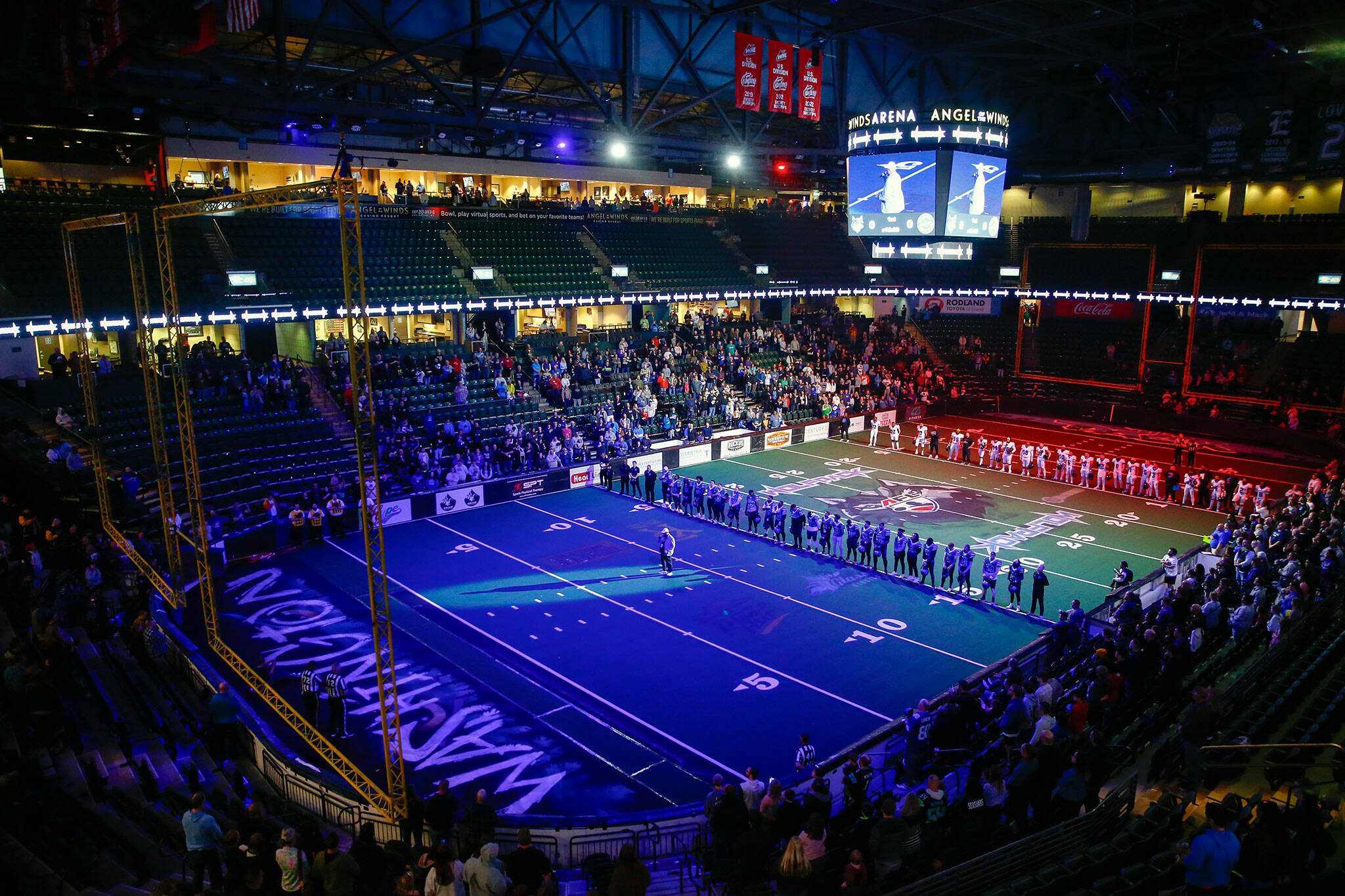 Teams stand on the field during the national anthem prior to the Washington Wolfpack’s inaugural home opener against Billings on Sunday, May 5, 2024, a Angel of the Winds Arena in Everett, Washington. (Ryan Berry / The Herald)