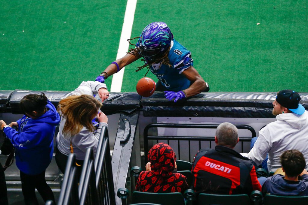 Receiver Vincent Wilkerson nearly catches a ball as he slams into the wall during the Washington Wolfpack’s inaugural home opener against Billings on Sunday, May 5, 2024, a Angel of the Winds Arena in Everett, Washington. (Ryan Berry / The Herald)
