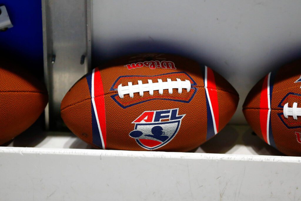 Arena Football League footballs are stocked on the bench during the Washington Wolfpack’s inaugural home opener against Billings on Sunday, May 5, 2024, a Angel of the Winds Arena in Everett, Washington. (Ryan Berry / The Herald)
