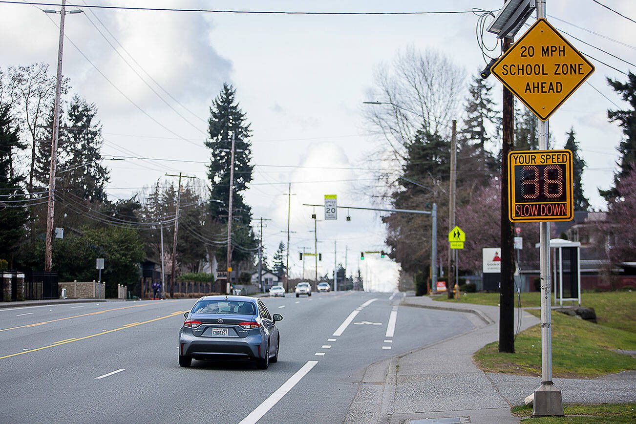 A car drives past a speed sign along Casino Road alerting drivers they will be crossing into a school zone next to Horizon Elementary on Thursday, March 7, 2024 in Everett, Washington. (Olivia Vanni / The Herald)