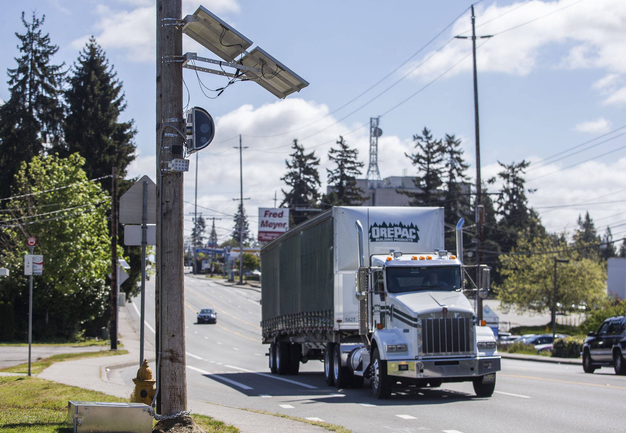 A truck drives west along Casino Road past a new speed camera set up near Horizon Elementary on Wednesday, May 8, 2024 in Everett, Washington. (Olivia Vanni / The Herald)