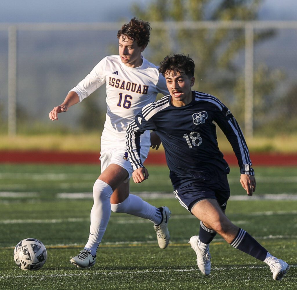 Issaquah’s Drew Clark-Bolt (16) and Glacier Peak’s Santiago Ballen-Pineda (18) fight for the ball during a Class 4A District 1/2 boys soccer game between Glacier Peak and Issaquah at Glacier Peak High School in Snohomish, Washington on Tuesday, May 7, 2024. Issaquah won, 2-1. (Annie Barker / The Herald)

