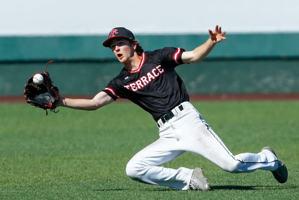 Mountlake Terrace left fielder Ryan Sturgill secures a sliding catch against Edmonds-Woodway in the Class 3A District 1 baseball championship Saturday, May 11, 2024, at Funko Field in Everett, Washington. (Ryan Berry / The Herald)
