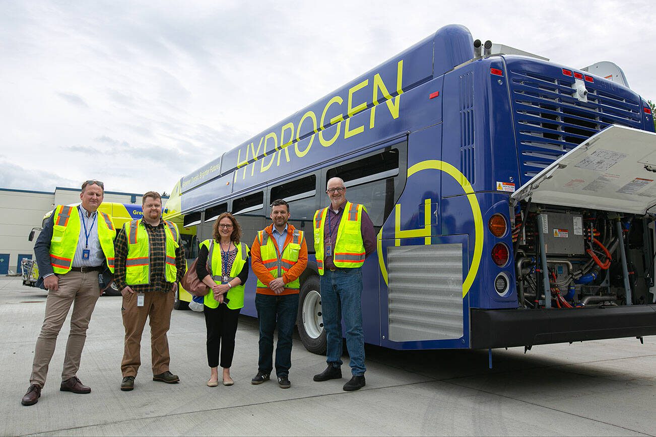Community Transit leaders, from left, Chief Communications Officer Geoff Patrick, Zero-Emissions Program Manager Jay Heim, PIO Monica Spain, Director of Maintenance Mike Swehla and CEO Ric Ilgenfritz stand in front of Community Transit’s hydrogen-powered bus on Monday, May 13, 2024, at the Community Transit Operations Base in Everett, Washington. (Ryan Berry / The Herald)
