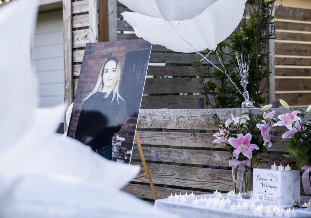 A photo of Liliya Guyvoronsky, 20, is set up outside her home during a vigil held on Tuesday, May 14, 2024 in Seattle, Washington. (Olivia Vanni / The Herald)
