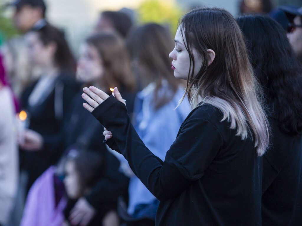 Kylie M. holds a candle during a vigil held in memory of Liliya Guyvoronsky on Tuesday, May 14, 2024 in Seattle, Washington. (Olivia Vanni / The Herald)
