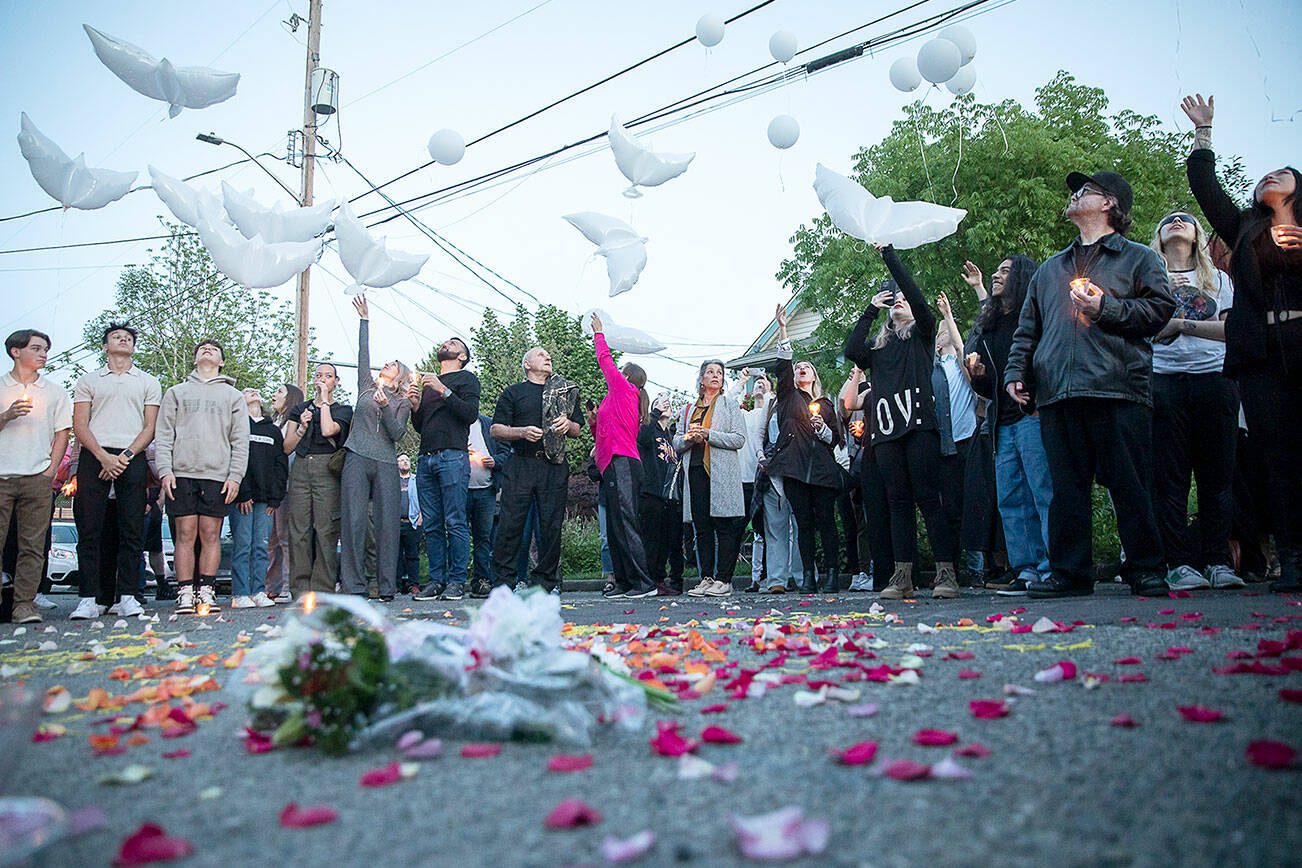 Family and friends of Liliya Guyvoronsky send up white balloons at a vigil held outside her home on Tuesday, May 14, 2024 in Seattle, Washington. (Olivia Vanni / The Herald)