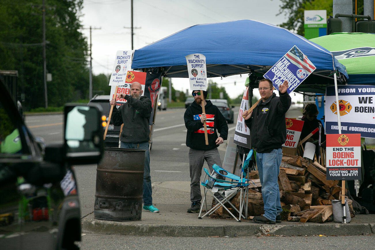 IAM District 751 machinists join the picket line to support Boeing firefighters during their lockout from the company on Thursday, May 16, 2024, in Everett, Washington. (Ryan Berry / The Herald)