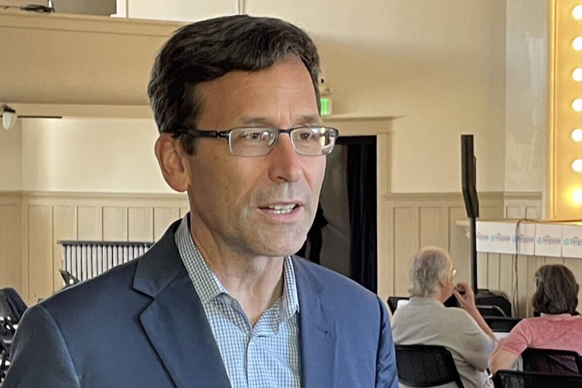 Attorney General Bob Ferguson speaks to a reporter as his 2024 gubernatorial campaign launch event gets underway in Seattle, on Saturday, Sept. 9, 2023. ( Jerry Cornfield/Washington State Standard)