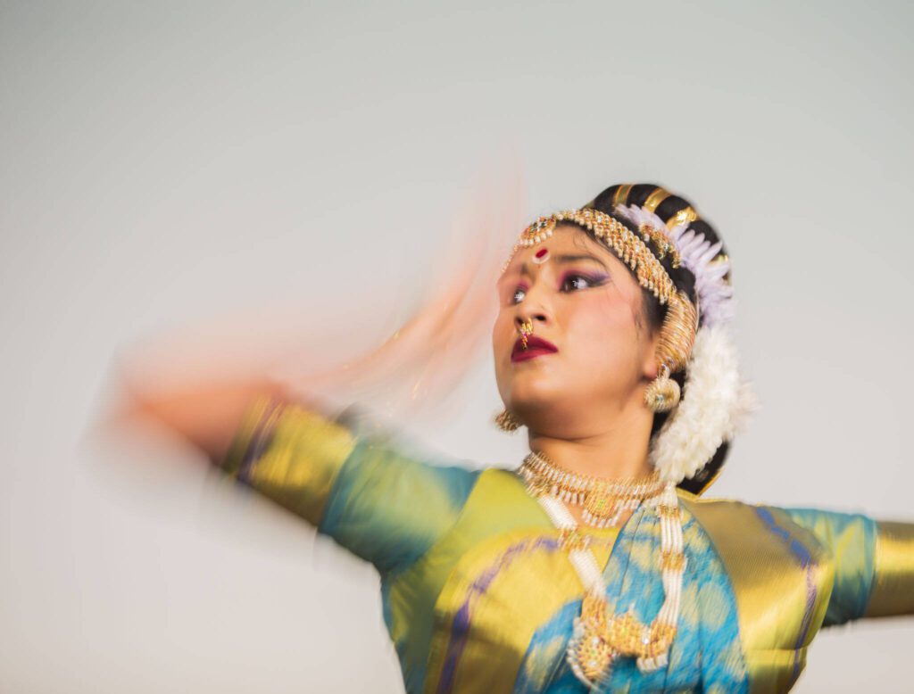 Jewelry glistens in the spotlight during a performance at the Desi Dazzle event at Everett Community College on Tuesday, May 14, 2024 in Everett, Washington. (Olivia Vanni / The Herald)

