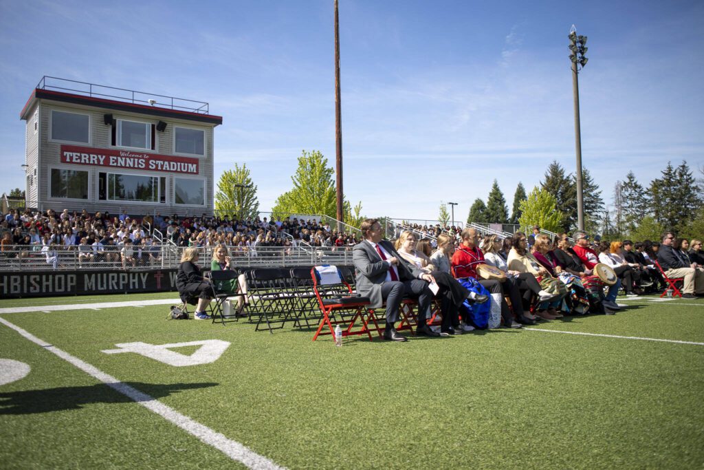 Students and guests listen during a ceremony for the healing pole students spent the last year carving along with Tulalip carver James Madison at Archbishop Murphy High School in Everett, Washington on Wednesday, May 15, 2024. (Annie Barker / The Herald)
