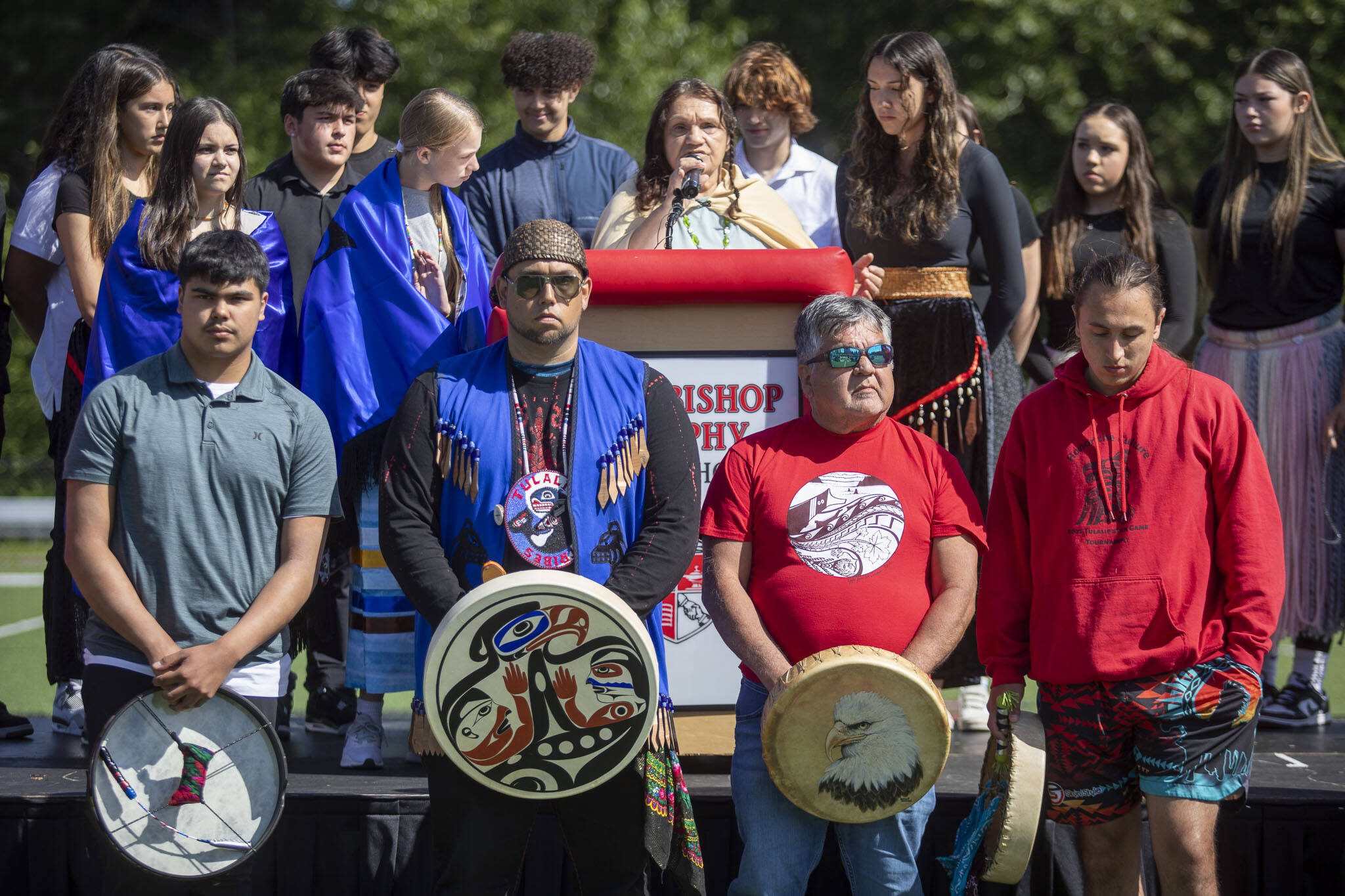 Gayle Jones leads a praryer during a ceremony for the healing pole students spent the last year carving along with Tulalip carver James Madison at Archbishop Murphy High School in Everett, Washington on Wednesday, May 15, 2024.  (Annie Barker / The Herald)