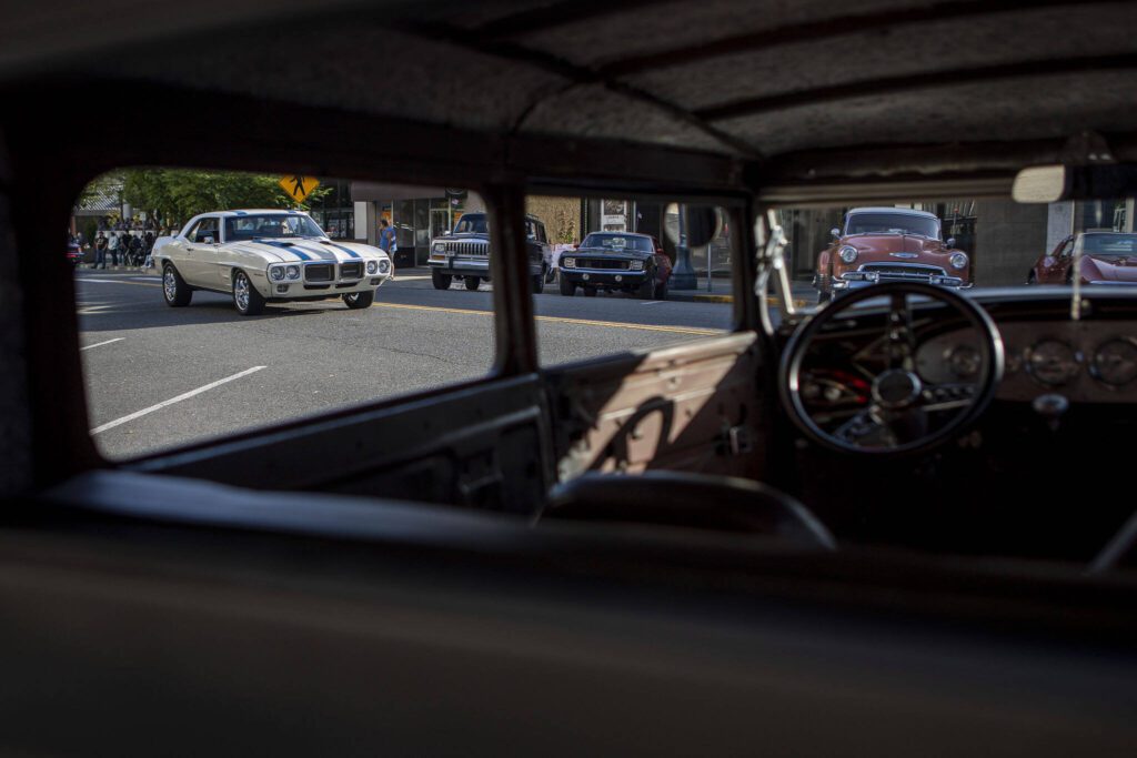 Cars drive around during the Cruzin’ to Colby event in downtown Everett, Washington on Sunday, May 28, 2023. (Annie Barker / The Herald)
