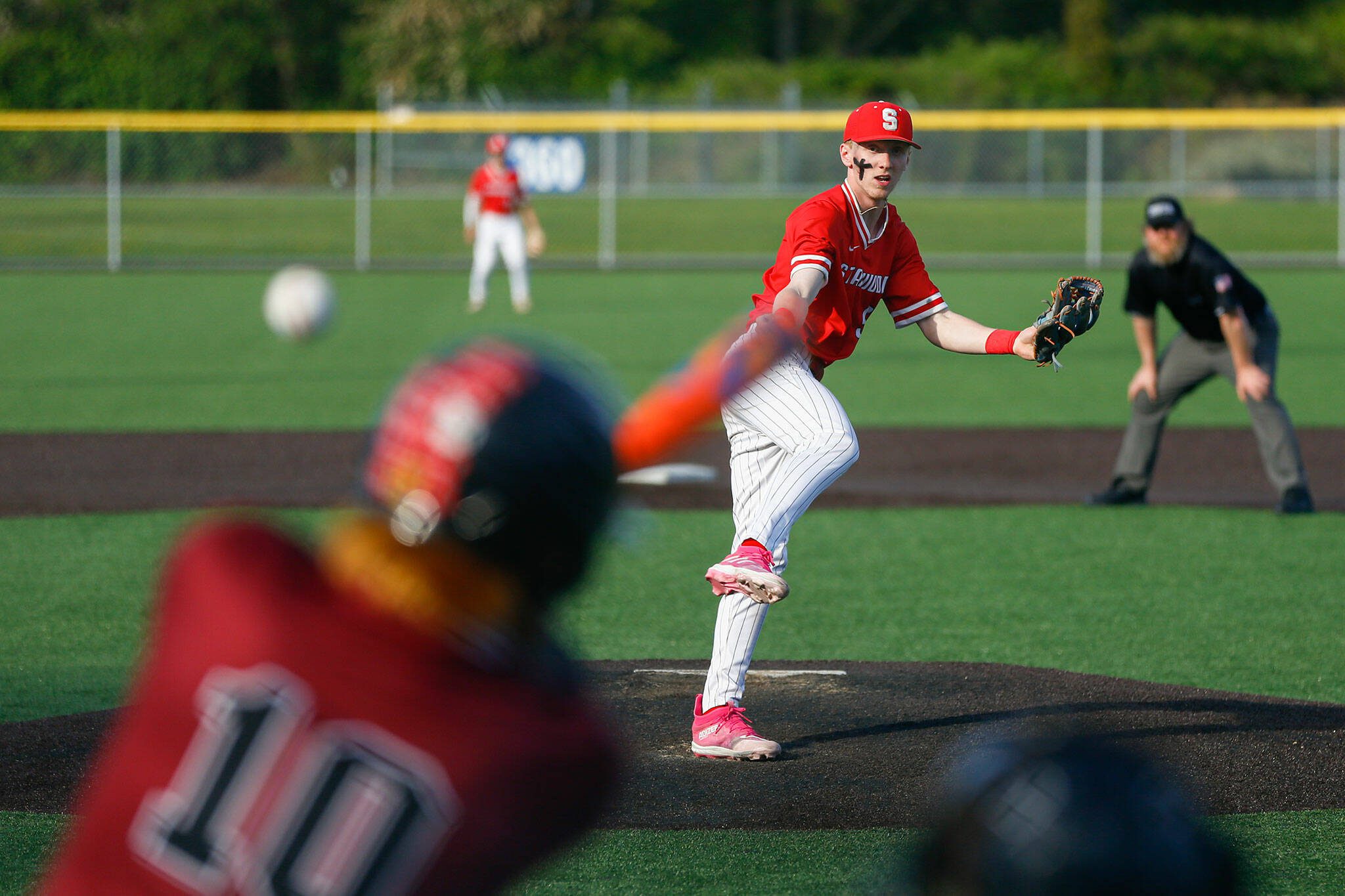 Stanwood reliever TJ McQuery gives up a hit to Juan Hernandez-Mendoza during a playoff loss to Kentlake on Tuesday, May 14, 2024, at Kent Meridian High School in Kent, Washington. (Ryan Berry / The Herald)