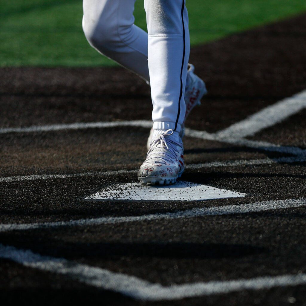 Kentlake’s Devin Tep scores a run in the first inning of a playoff win over Stanwood on Tuesday, May 14, 2024, at Kent Meridian High School in Kent, Washington. (Ryan Berry / The Herald)
