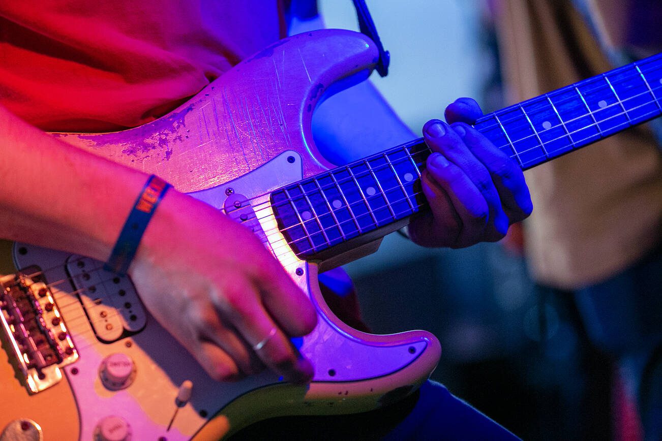 A guitarist keeps rhythm during Lovely Color’s set on the opening night of Fisherman’s Village on Thursday, May 18, 2023, at Black Lab in Everett, Washington. (Ryan Berry / The Herald)