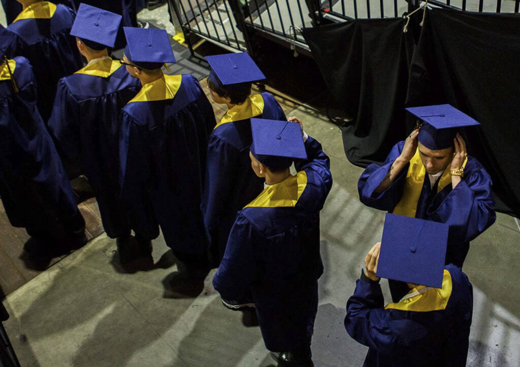 Students from Everett High School stand in line waiting to walk onto the floor for graduation at Angel of the Winds Arena on Saturday, June 15, 2018 in Everett, Wash. (Olivia Vanni / The Herald)
