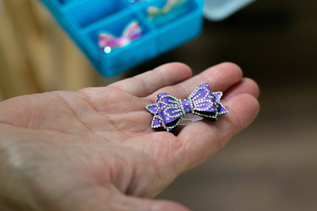 Kathy West holds Pippin’s Westminster bow on Monday, May 20, 2024, in Marysville, Washington. (Ryan Berry / The Herald)
