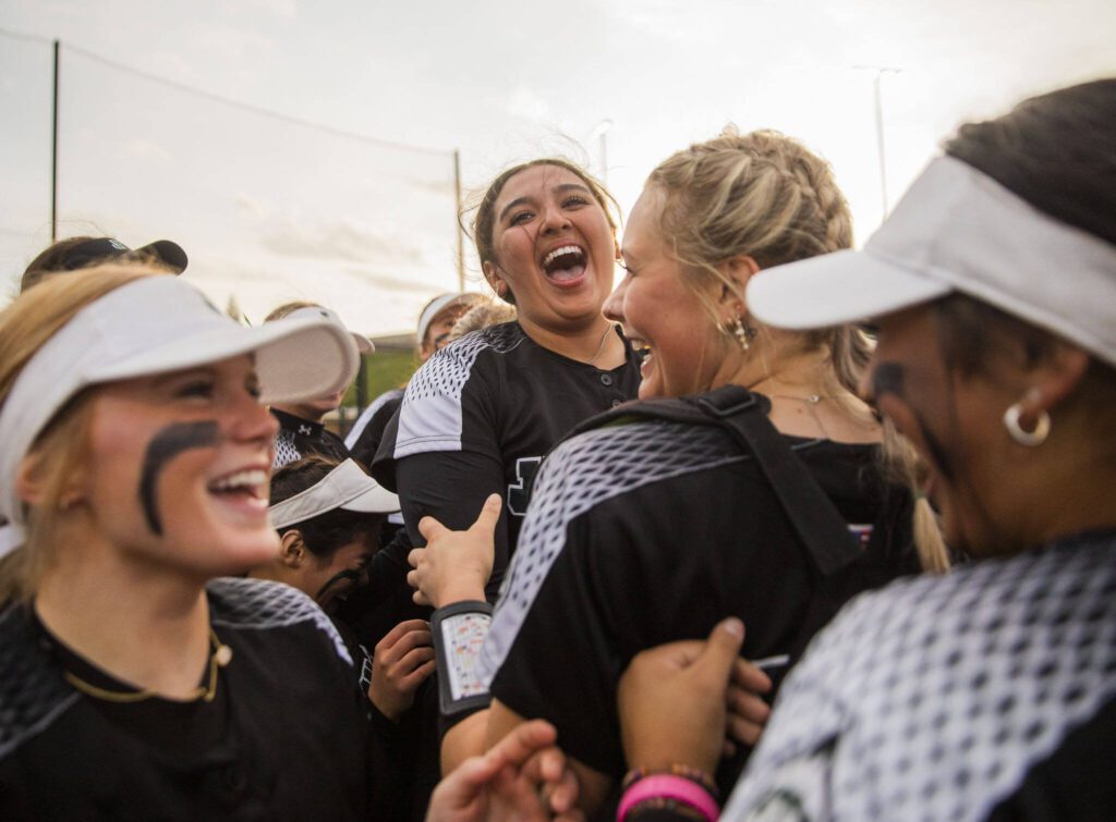 Jackson’s Yanina Sherwood smiles and hugs her teammates after beating Kamiak to win the 4A district championship on Friday, May 17, 2024 in Everett, Washington. (Olivia Vanni / The Herald)
