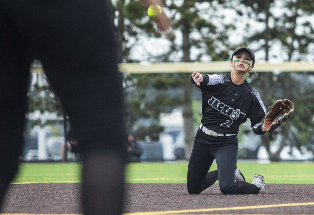 Jackson’s Reese Westman fields a hit and throws the ball to first from the ground during the 4A district championship against Kamiak on Friday, May 17, 2024 in Everett, Washington. (Olivia Vanni / The Herald)
