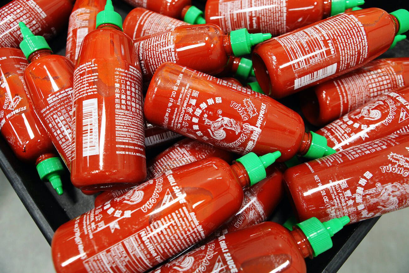 FILE — Newly filled bottles of Sriracha hot sauce at Huy Fong Foods in Irwindale, Calif., on April 28, 2014. Huy Fong, the maker of the most popular variety of Sriracha sauce, told distributors in May 2024 that it would halt production of all its products until at least September, rekindling fears of another prolonged shortage of the beloved condiment. (Emily Berl/The New York Times)