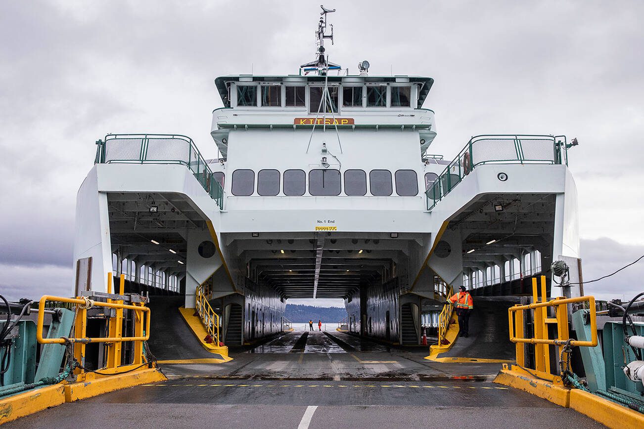 Ferry workers wait for cars to start loading onto the M/V Kitsap on Friday, Dec. 1, 2023 in Mukilteo, Washington. (Olivia Vanni / The Herald)
