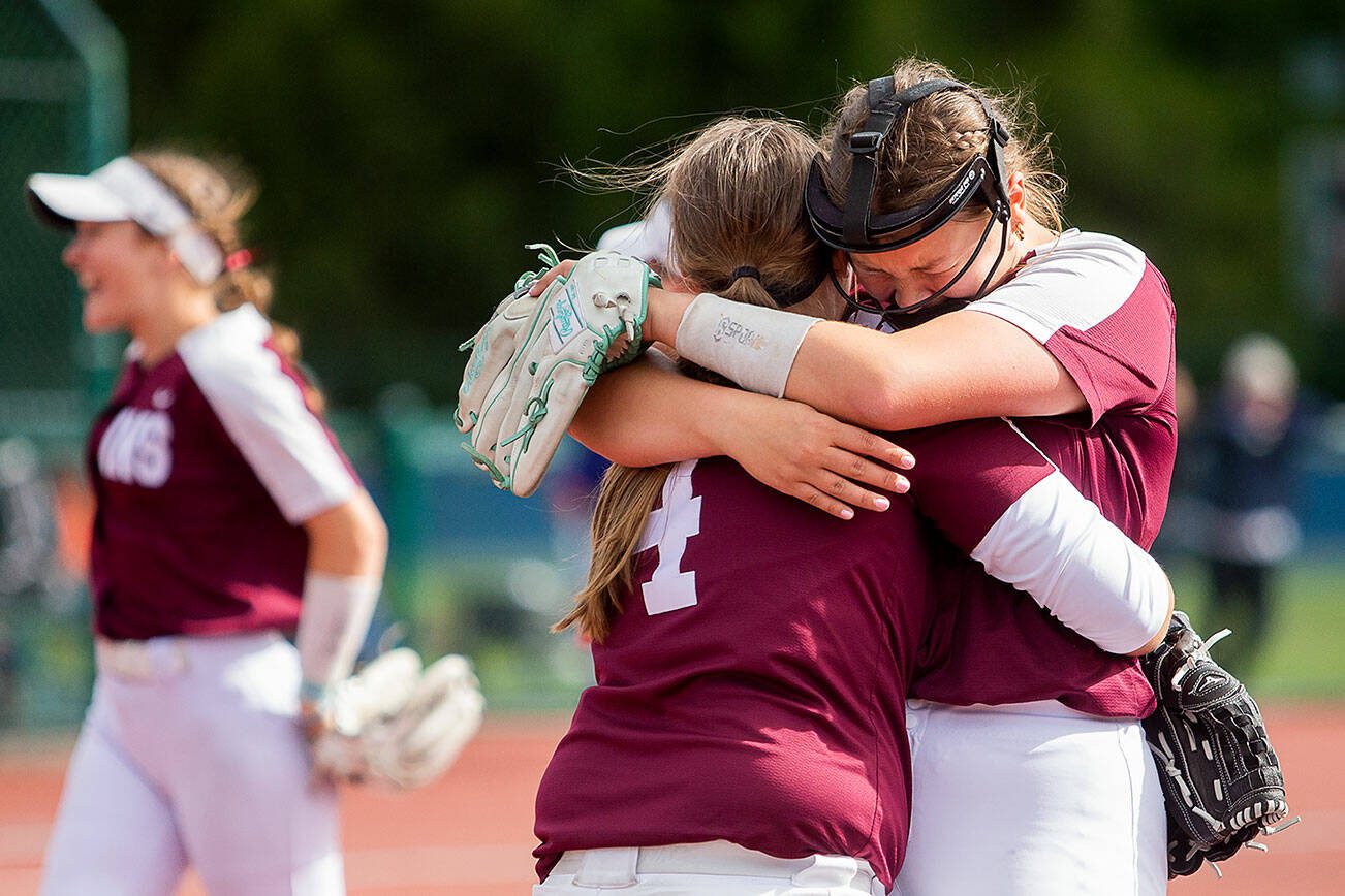Cascade’s Mia Walker, right, cries and hugs teammate Allison Gehrig after beating Gig Harbor on Thursday, May 23, 2024 in Lacey, Washington. (Olivia Vanni / The Herald)