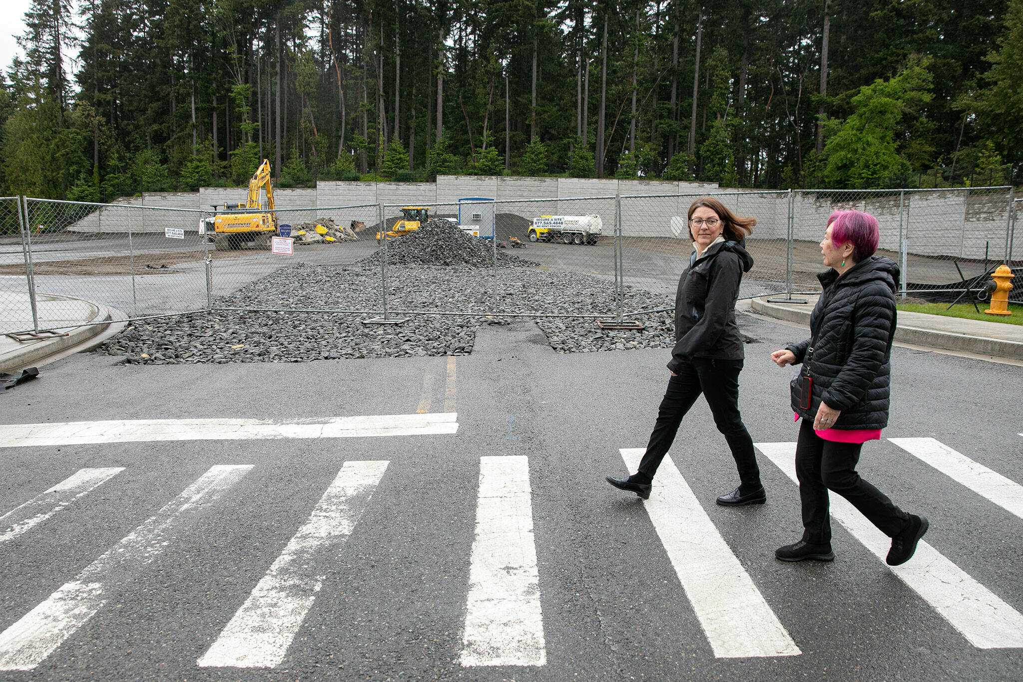 Rep. Suzan DelBene and Mayor Kyoko Matsumoto-Wright walk past a future apartment development during a tour and discussion with community leaders regarding the Mountlake Terrace Main Street Revitalization project on Tuesday, May 28, 2024, in Mountlake Terrace, Washington. (Ryan Berry / The Herald)