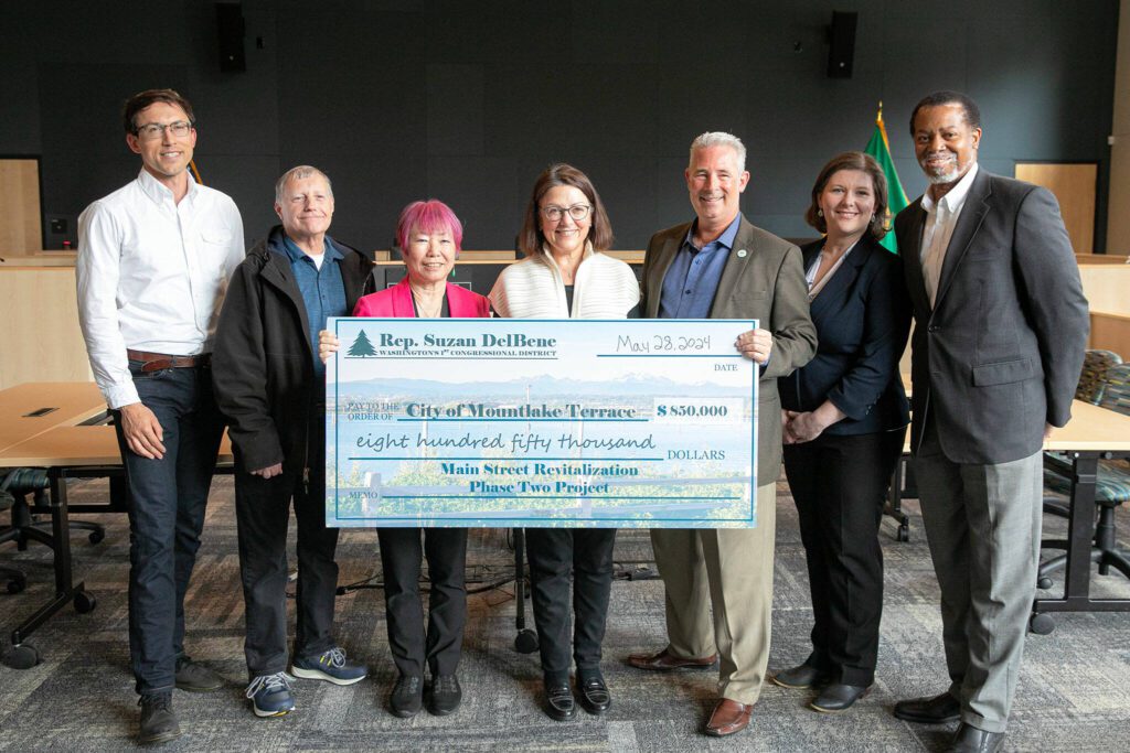 Rep. Suzan DelBene, center, presents a check worth $850,000 to the city of Mountlake Terrace as part of its Main Street Revitalization project on Tuesday, May 28, 2024, a the city’s council chambers in Mountlake Terrace, Washington. (Ryan Berry / The Herald)
