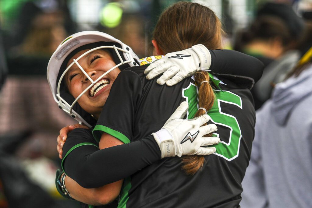 Roosevelt’s Maddie Lee (1) and Gretchen Harder (15) hug during a 3A softball game between Everett and Roosevelt at the regional athletic complex in Lacey, Washington on Friday, May 24, 2024. Everett fell in the eighth, 7-8. (Annie Barker / The Herald)
