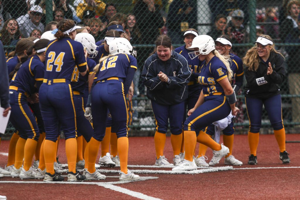 Players celebrate Everett’s Haylie Oyler (13) home run during a 3A softball game between Everett and Roosevelt at the regional athletic complex in Lacey, Washington on Friday, May 24, 2024. Everett fell in the eighth, 7-8. (Annie Barker / The Herald)
