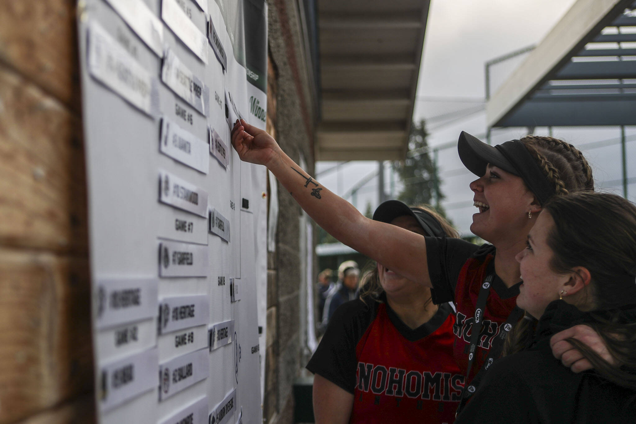 Snohomish players move their teamname up the bracket after a 3A softball game between Snohomish and Seattle Prep at the regional athletic complex in Lacey, Washington on Friday, May 24, 2024. Snohomish won, 8-0. (Annie Barker / The Herald)
