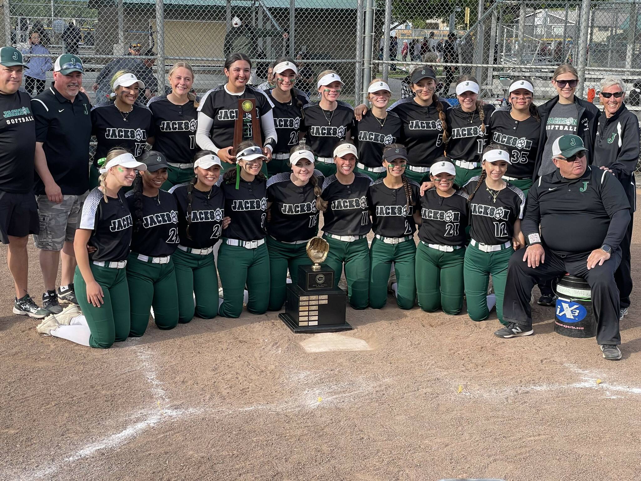 The Jackson softball team poses with the Class 4A state tournament trophy after a 10-1 triumph over Emerald Ridge Saturday, May 25 at Columbia Playfield in Richland, WA. (Aaron Coe / The Herald).