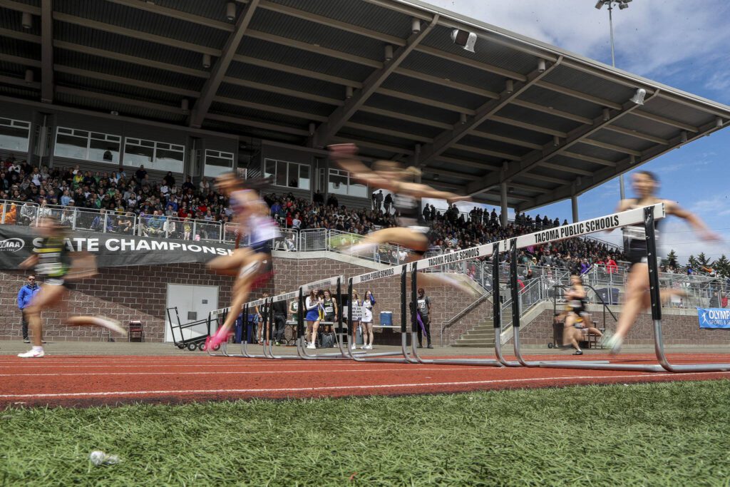 Runners participate in a Girls 300M hurdle race during the Class 4A, 3A, 2A track and field state championships at Mount Tahoma High School in Tacoma, Washington on Saturday, May 25, 2024. (Annie Barker / The Herald)
