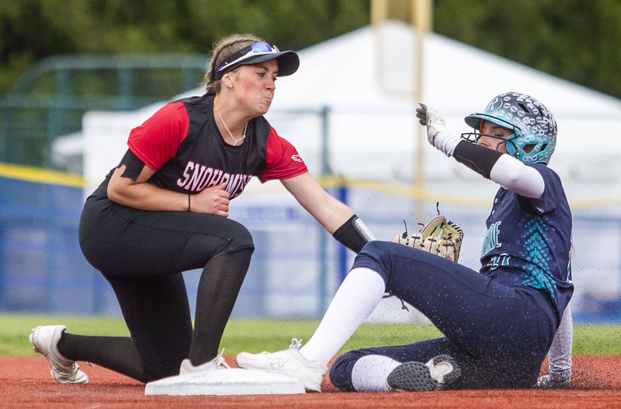 Snohomish’s Camryn Sage reaches to try and tag out an Auburn player as they slide into second base during the 3A state softball championship game against Auburn Riverside on Saturday, May 25, 2024 in Lacey, Washington. (Olivia Vanni / The Herald)