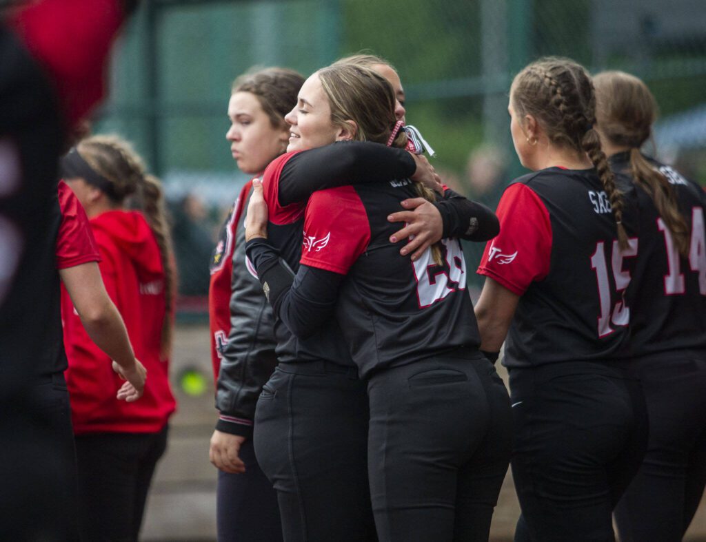 Snohomish players hug after losing to Auburn Riverside in the 3A state softball championship game on Saturday, May 25, 2024 in Lacey, Washington. (Olivia Vanni / The Herald)
