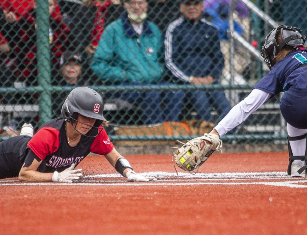 Snohomish’s Camryn Sage slides into home to score during the 3A state softball championship game against Auburn Riverside on Saturday, May 25, 2024 in Lacey, Washington. (Olivia Vanni / The Herald)
