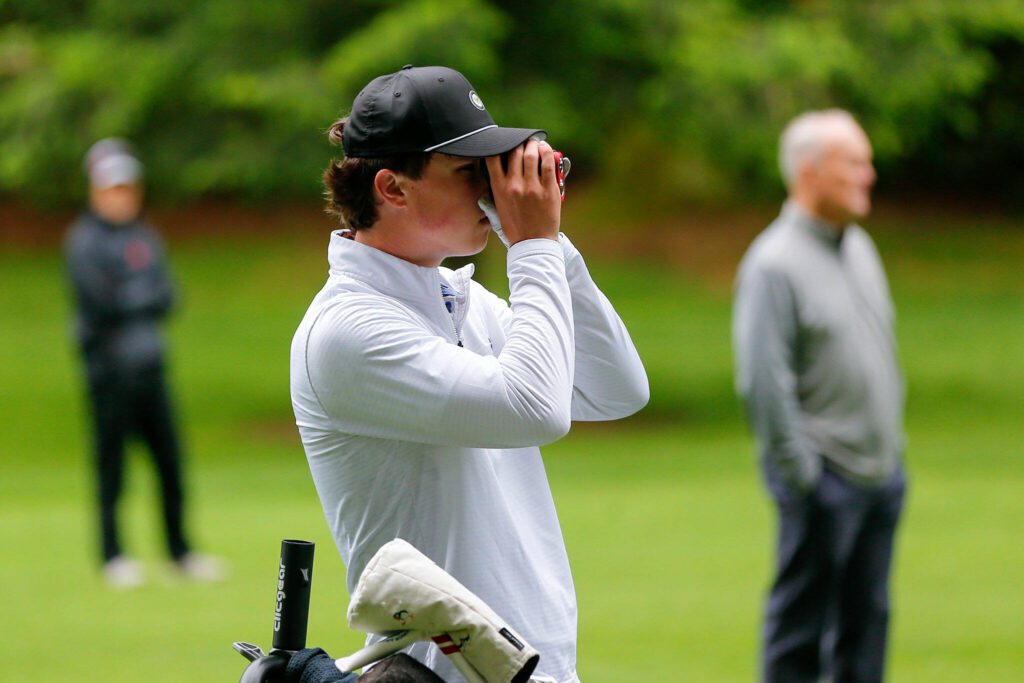 Palmer Mucheson uses his rangefinder during the 93rd Annual Snohomish County Amateur Championship on Monday, May 27, 2024, at the Everett Golf and Country Club in Everett, Washington. (Ryan Berry / The Herald)
