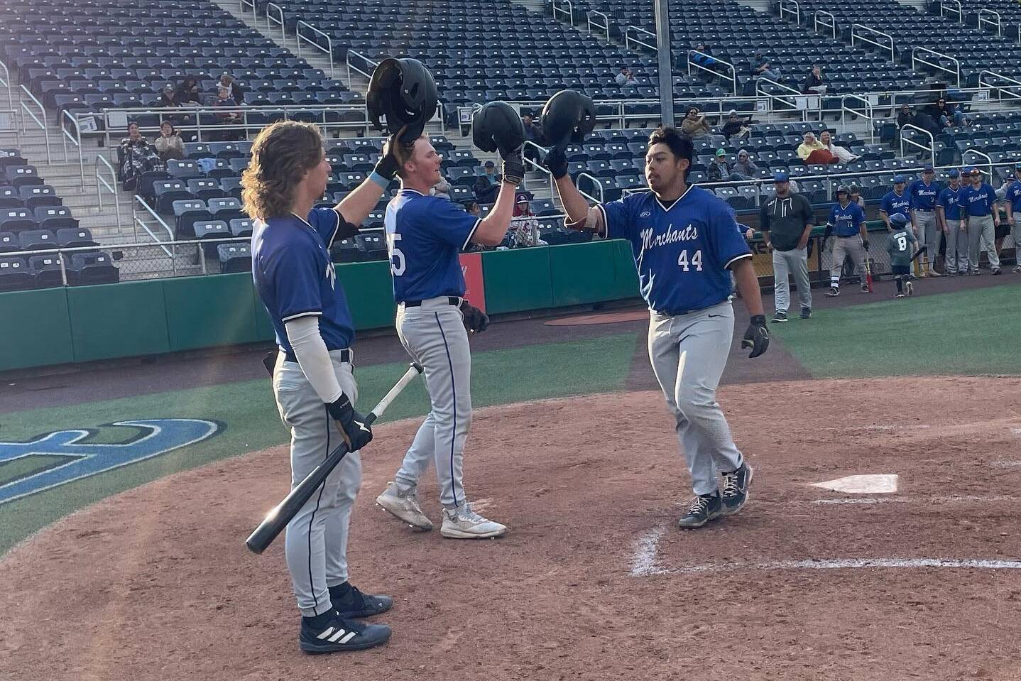 The Everett Merchants’ Aaron Barber, who is returning this season, is greeted by teammates at home plate. (Photo courtesy of the Everett Merchants).