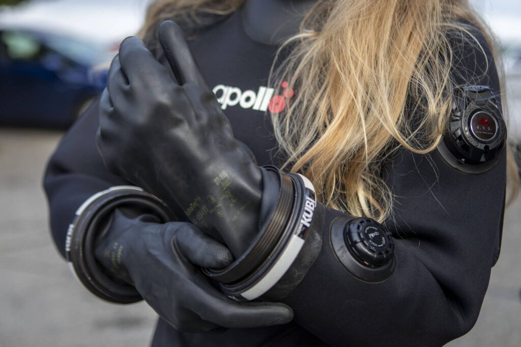Annie Crawley puts on gear for a portrait at Brackett’s Landing near the Port of Edmonds on Saturday, Feb. 3, 2024 in Edmonds, Washington. (Annie Barker / The Herald)
