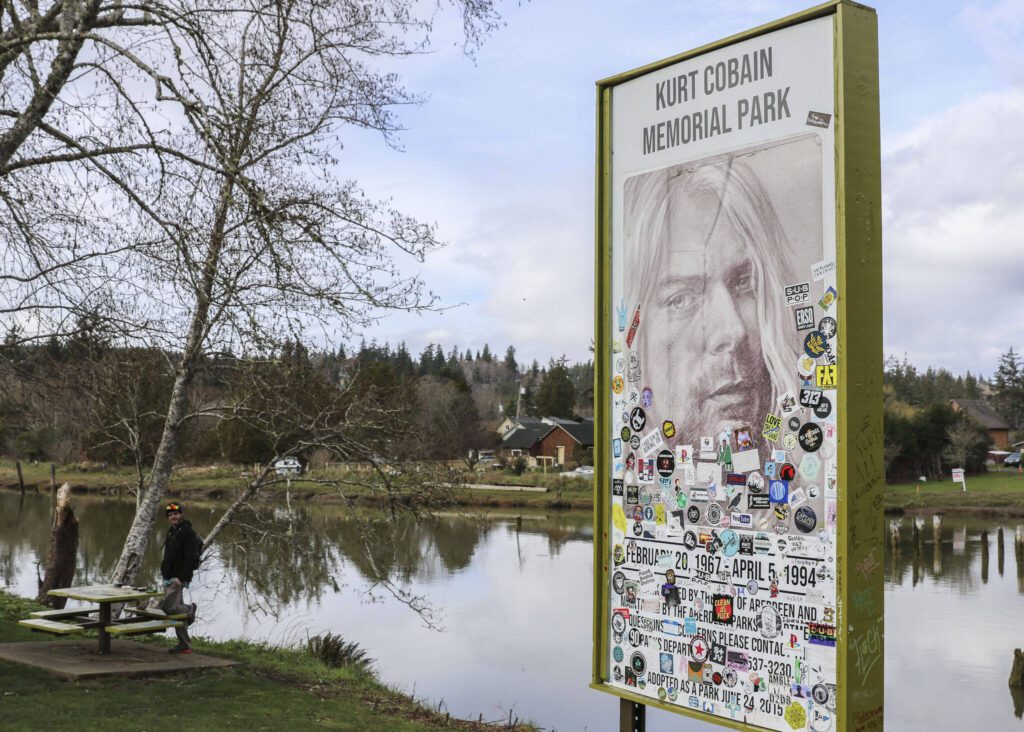 A sign with a portrait of Kurt Cobain at the Kurt Cobain Memorial Park on March 13 in Aberdeen, Washington. The park, located on the muddy shores of Wishkah River where the Nirvana frontman would hang out, includes several tributes to his memory and attracts visitors from around the world. (Brenda Mann Harrison / Special to The Herald)
